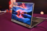 Modern laptop displaying a vibrant landscape on screen.
