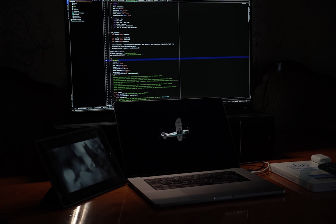 a laptop computer sitting on top of a wooden desk